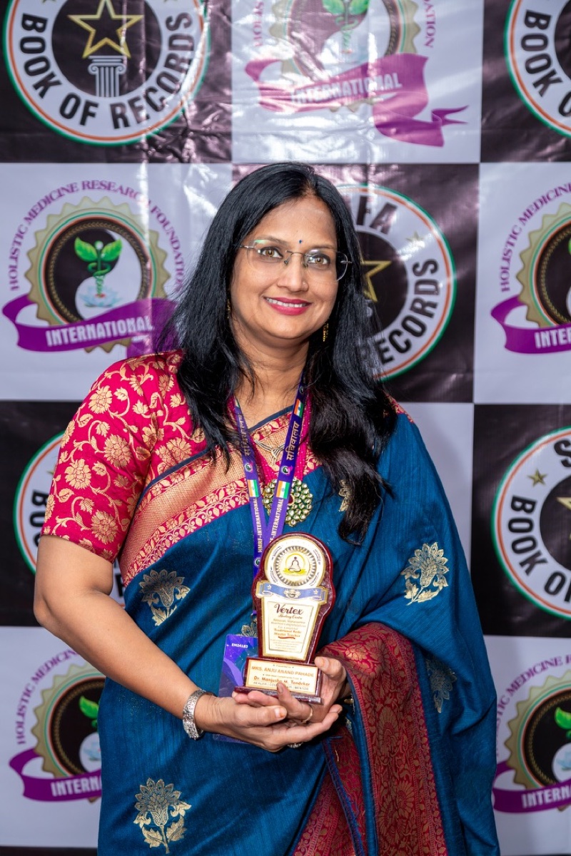 Grand Master Anju Pahade receiving an award, honoured by the International Book of Records and Holistic Medicine Research Foundation